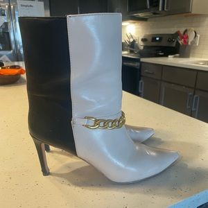 White and black boots with gold chain.